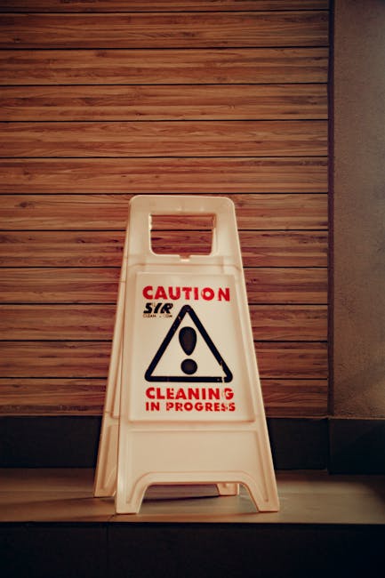 Close-up of a person's hand holding a silver pen and filling out a 'Home Insurance Policy' form on a clipboard, with the person's dark hair partially visible in the background. The form includes secti
